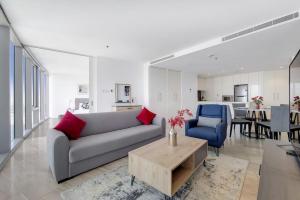 a living room with a couch and a table at D1, Al Jadaf Modern One Bedroom Apartment in Dubai