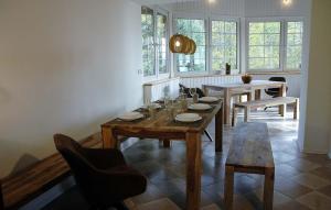 a dining room with a wooden table and chairs at Horská chalupa Izerina in Zlatá Olešnice