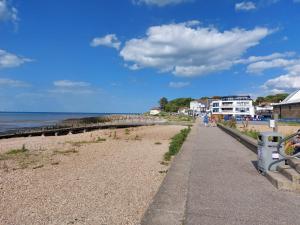 a sidewalk next to a beach with a pier at Inviting 1-Bed Apartment in Herne Bay in Herne Bay