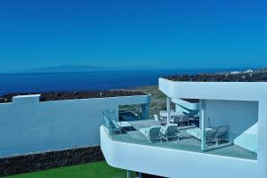 a house with chairs and the ocean in the background at Villa Deluxe 1&2 - Casangular by Upper in Adeje