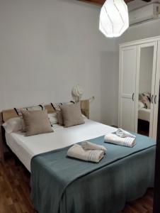 a bedroom with a large bed with two towels on it at Azahar in Seville