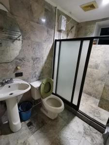 a bathroom with a toilet and a sink at Comfort room in Manila