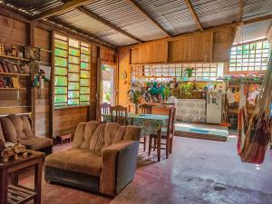 a living room with a table and chairs and a kitchen at ROSA'S HOUSE in Puerto Maldonado