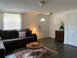 a living room with a couch and a table at Minutes to the beach! 4-bedroom home, free parking in Hampton
