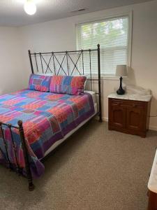 a bedroom with a bed and a table and a window at Minutes to the beach! 4-bedroom home, free parking in Hampton