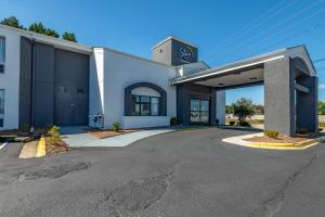 a large white building with a parking garage at Sleep Inn - Salisbury I-85 in Salisbury