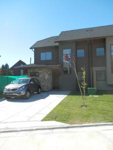 a car parked in the driveway of a house at Casa Costa Pucón in Pucón