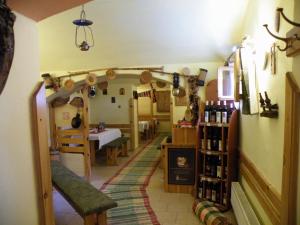 a hallway with a room with a table and some wine bottles at Sunnystreet Guesthouse in Stará Lesná