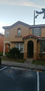 a house on the side of a street at Kissimmee townhome 3 miles to Disney! in Orlando