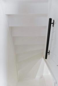 a white room with a shelf with two hooks on it at Au Numéro 5 in Tilff