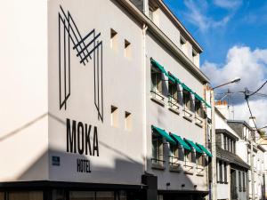 洛里昂的住宿－MOKA Hôtel，上面有摩西娅标志的白色建筑