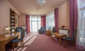 a living room with a desk and chairs at Willa Excelsior in Zakopane