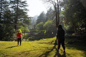 two people standing in a field playing with a kite at Everest Base Camp, Near George Everest House, 5kms from Library chowk in Mussoorie