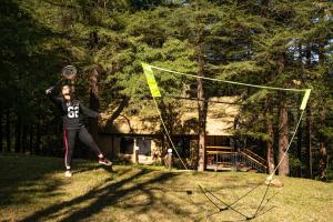 a woman is playing with a frisbee on a net at Everest Base Camp, Near George Everest House, 5kms from Library chowk in Mussoorie +110 photos