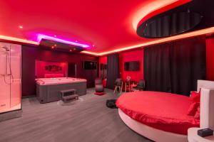 a red bedroom with a bed and a bath room at Secret Night in Toulouse