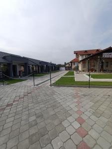 a cobblestone street in a town with buildings at VILA GE in Sebeş
