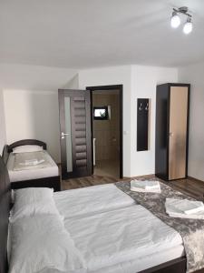a bedroom with a large bed with two towels on it at VILA GE in Sebeş