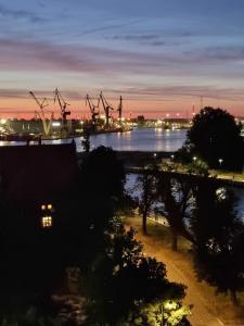 a view of a harbor at night at RentPlanet - Apartamenty Chlebova II in Gdańsk