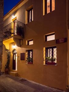 a building with windows and balconies at night at Casa Theano - Old Town in Rhodes Town