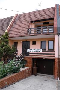 a house with a sign on the front of it at Ubytovanie Viktória in Dunajská Streda