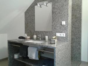 un bagno con lavandino e specchio di DZT-Schwarzwaldhotel garni a Unterkirnach Altre 18 foto