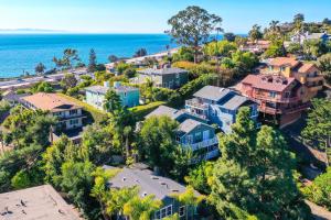 an aerial view of a home with the ocean in the background at Cozy Cali Condo, Walk to Summerland Beach! in Summerland