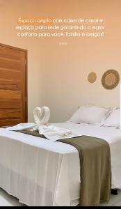 - une chambre avec un lit doté d'un couvre-lit blanc dans l'établissement POUSADA SOLAR DOS MOREIRAS, à Guajiru