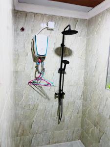 a shower in a bathroom with a sink and a shower at Ruyer one bedroom in Kisumu