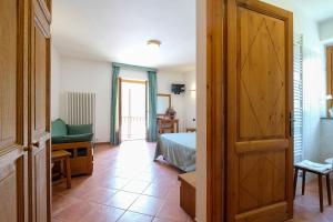 a room with a bed and a door to a bedroom at Hotel Casalpina Don Barra in Pragelato