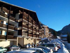 a parking lot with cars parked in front of a building at Appartement Châtel, 2 pièces, 5 personnes - FR-1-200-164 in Châtel