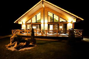 a house lit up at night with lights at Vila Elis in Veľká Lomnica
