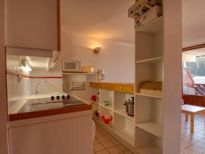 a small kitchen with a sink and a microwave at Appartement Morillon 1100, 3 pièces, 6 personnes - FR-1-642-37 in Morillon