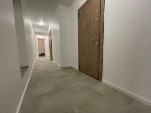 a hallway with a door and a tile floor at Modern guest house in city center I Room 3 in Vilnius +2 photos