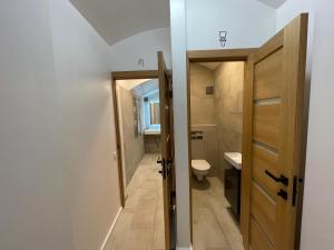 a small bathroom with a toilet and a door at Modern guest house in city center I Room 3 in Vilnius