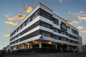 a large white building with a sign on it at Hotel del Parque in Matehuala