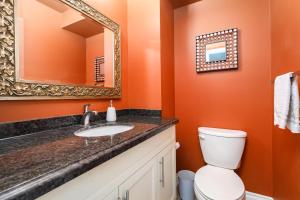 a bathroom with a sink and a toilet and a mirror at Spacious & Quiet 4bd House in Prime Location! Upper 2 Levels! in Mississauga