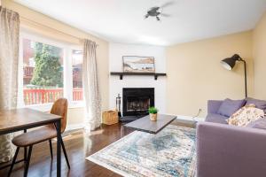 a living room with a couch and a table and a fireplace at Spacious & Quiet 4bd House in Prime Location! Upper 2 Levels! in Mississauga
