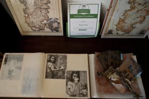 an open book sitting on a table with pictures at Nascar Hotel in Santa Maria Navarrese