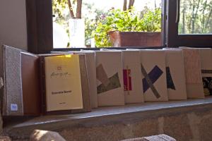 a row of books sitting on a window sill at Nascar Hotel in Santa Maria Navarrese
