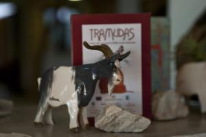 a figurine of a cow next to a book at Nascar Hotel in Santa Maria Navarrese