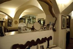 a room with a counter with a mirror and a shelf at Nascar Hotel in Santa Maria Navarrese