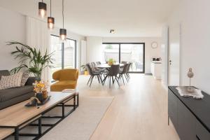 a living room with a couch and a table at Villa Stijn in Middelkerke