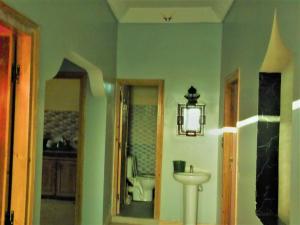 a bathroom with a sink and a toilet at Tifinagh Guest House in Merzouga +66 photos