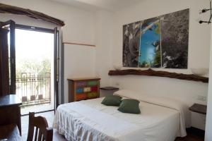 a bedroom with a bed and a large window at Nascar Hotel in Santa Maria Navarrese