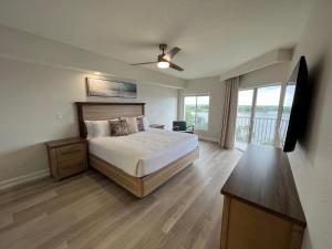 a bedroom with a large bed and a balcony at 5 minutes away from Disney, Westgate Resort in Orlando