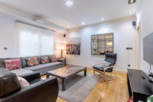 a living room with a couch and a table at Azkuna Comfort Bilbao in Bilbao