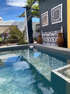 a swimming pool in a yard with a house at Villa Contessa in Beaufort West