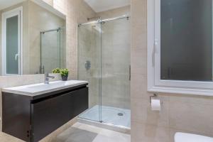a bathroom with a sink and a shower at Azkuna Comfort Bilbao in Bilbao +22 photos