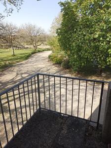 a gate on a walkway next to a road at La tourelle 82 in Saint-Antonin