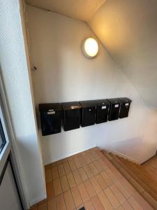 a bathroom with a row of urinals on a wall at Lillehammer Guest House with common bath and kitchen in Lillehammer